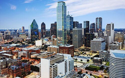 Downtown Dallas skyline under a bright blue sky
